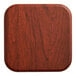 A close up of a Lancaster Table & Seating square wooden table top with a red mahogany finish.