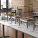 A buffet table with food on it including an Acopa wrought iron chafer kit with stainless steel cover and handle.