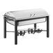 An Acopa wrought iron chafer with roll top lid on a table outdoors.