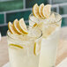 Two glasses of liquid with Mixologist's Garden freeze-dried lime slices and ice.