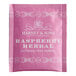 A pink Harney & Sons Raspberry Herbal Tea box with white text.