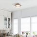 A kitchen with white cabinets and a Globe matte black LED light fixture.