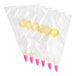 A row of six Wilton plastic pastry bags with open star tips.