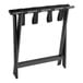 A black wood Lancaster Table & Seating folding luggage rack with straps.