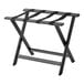 A Lancaster Table & Seating black wood folding luggage rack with straps.