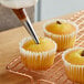 A cupcake with a piped filling using a Wilton Bismark piping tip.