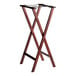 A Lancaster Table & Seating mahogany wood folding tray stand with two legs.