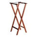 A Lancaster Table & Seating wooden folding tray stand with two legs.