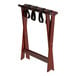 A Lancaster Table & Seating mahogany wood folding luggage rack with black straps.