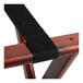 A Lancaster Table & Seating mahogany wood folding luggage rack with a black strap.