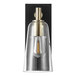A Globe Modern Farmhouse Matte Black and Brass Wall Sconce with Clear Glass Shade.