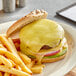 A cheeseburger with Tillamook medium white cheddar cheese and fries on a plate.