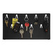 A black Pyramid Time Systems key rack with 9 hooks holding keys.