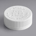 A 38/400 white plastic child-resistant cap with foam liner and the words "push down and close" on it.