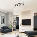 A modern living room with a Globe Matte Black Island Light above a white surface.