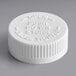 A white plastic 38/400 child-resistant cap with instructions to push down and close.