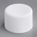 A 20/410 white plastic bottle cap with foam liner.