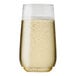 A close up of a Tossware POP 6 oz. plastic champagne flute full of champagne with bubbles.