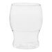 A close up of a clear Tossware plastic pint glass with a curved bottom.