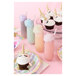 A Tossware plastic champagne flute with a cupcake with a unicorn horn on top.