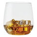 A Tossware POP plastic Vino Jr. glass with ice and amber liquid.