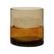 A Tossware Reserve Go-To Smoke Tritan plastic rocks glass filled with brown liquid and ice cubes.