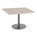 A Holland Bar Stool square table with a stainless steel base.