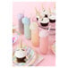 A Tossware plastic champagne flute with a cupcake on top with a unicorn horn.