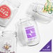 A set of customizable clear plastic mason jars with various printed logos and designs.