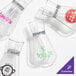 A group of Tossware decanters with different logos.