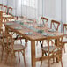 A Lancaster Table & Seating Vineyard Series barrel brown folding table and chairs set in a restaurant dining area.