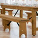 A Lancaster Table & Seating Vineyard Series outdoor folding bench with a wooden barrel design.