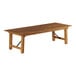 A Lancaster Table & Seating Vineyard Series outdoor folding table with a wooden top and metal legs.