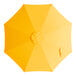 A yellow umbrella canopy for a round table with a white background.