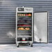 A large stainless steel Pro Classic Electric Smokehouse with food inside.