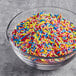 A bowl of Supernatural Rainbow Softies sprinkles on a table.