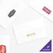 A group of Tork white dispenser napkins with different logos and colors on them.