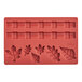 A red silicone Wilton leaf shaped mold for pie crusts.