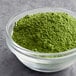 A white bowl filled with green Dona Kyoto Ceremonial matcha powder.