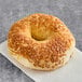 A Just Bagels asiago bagel on a napkin.