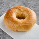 A Just Bagels sundried tomato bagel on a white surface.