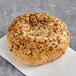 A Just Bagels everything bagel with seeds on it.