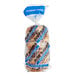 A bag of Just Bagels blueberry bagels with blue text on the bag.
