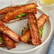 A plate of Thrilling Foods Plant-Based Vegan Bakon sandwiches with avocado.