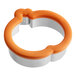 A metal Wilton cookie cutter with an orange handle.