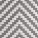 A close up of the woven white and gray rattan on a Lancaster Table & Seating Bistro Series outdoor side barstool.