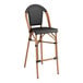 A Lancaster Table & Seating black Teslin outdoor side barstool with a wooden frame and black seat.
