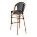A Lancaster Table & Seating black Teslin outdoor barstool with a wooden frame and black seat.