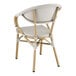 A gray Lancaster Table & Seating outdoor arm chair with a white seat.