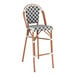 A Lancaster Table & Seating outdoor restaurant bar stool with a black and white birdseye weave rattan seat.